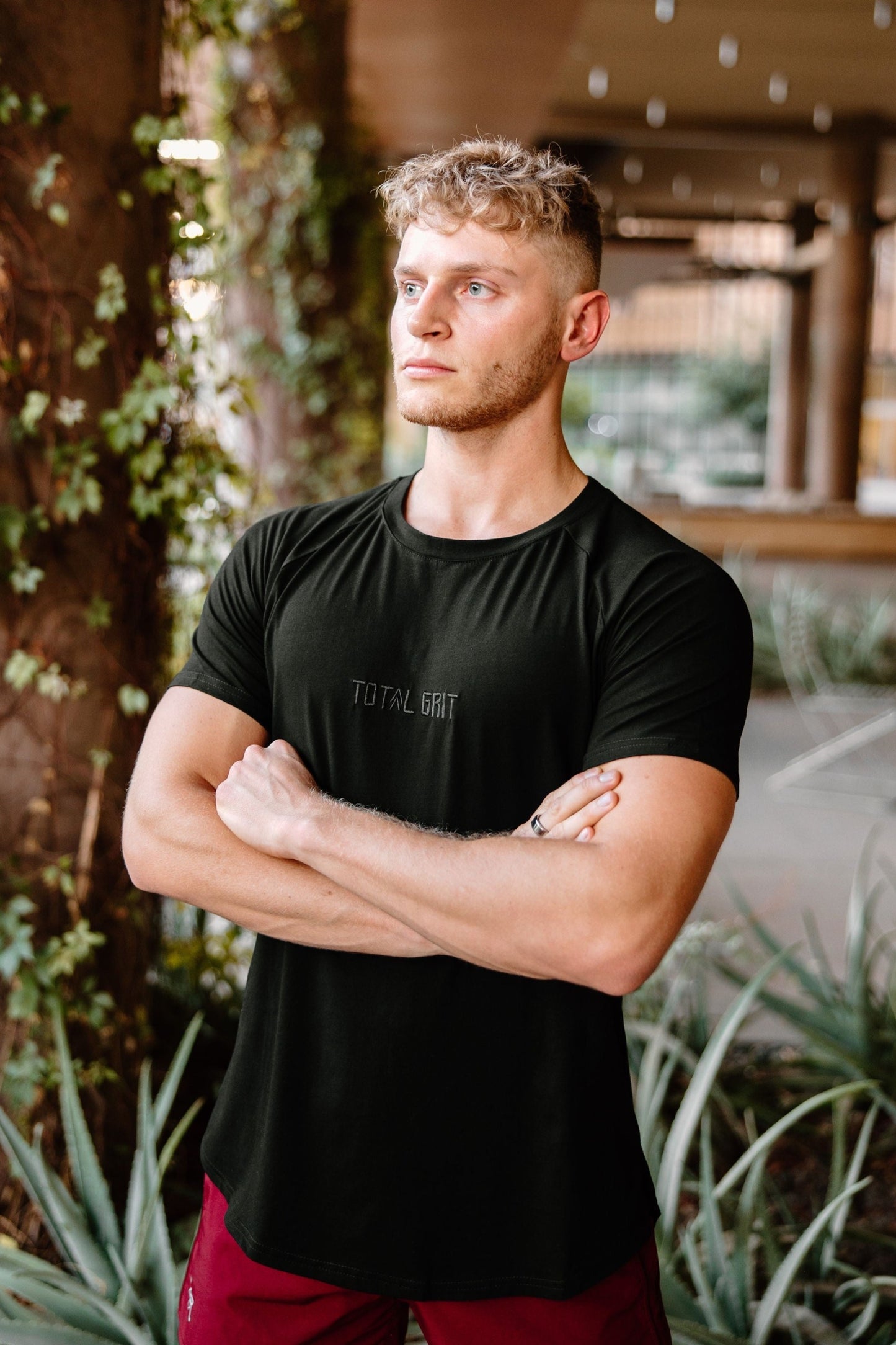 Black Total Grit fitted/athletic tee. Custom embroidered logo on the front, and double caret logo on the back.