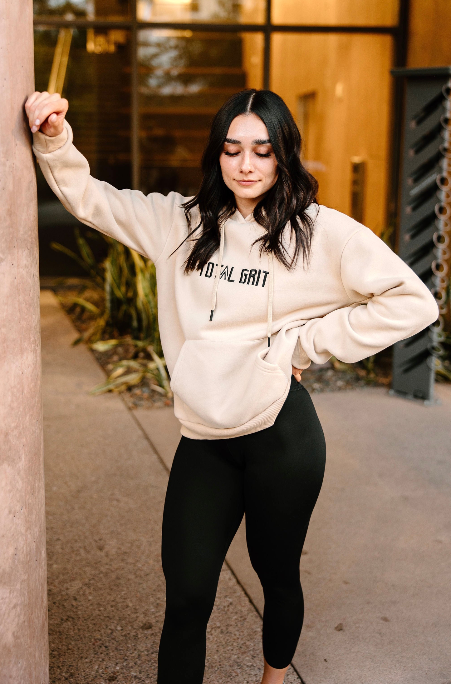 Khaki Total Grit Pastel Hoodie, showing off a female model, with drawstrings as the feature.