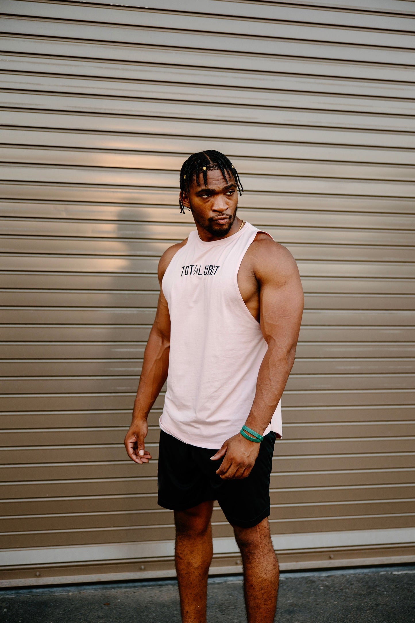 Salmon Total Grit cut-off tank. Can be worn out in a casual setting to show off your hard work, or in the gym where you do the hard work.