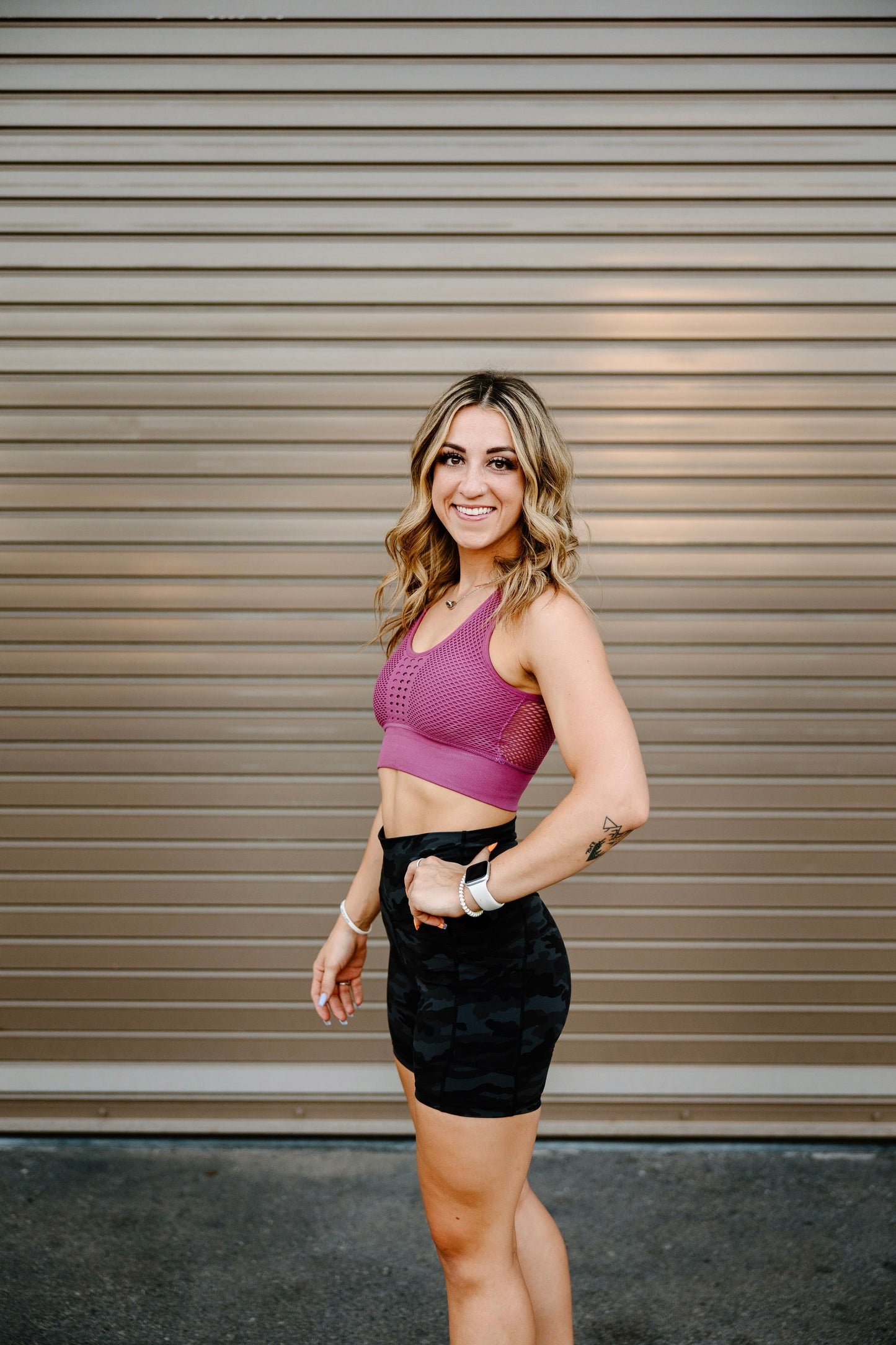 Vibrant pink Total Grit Sports Bra - unique and breathable webbing design in the back.