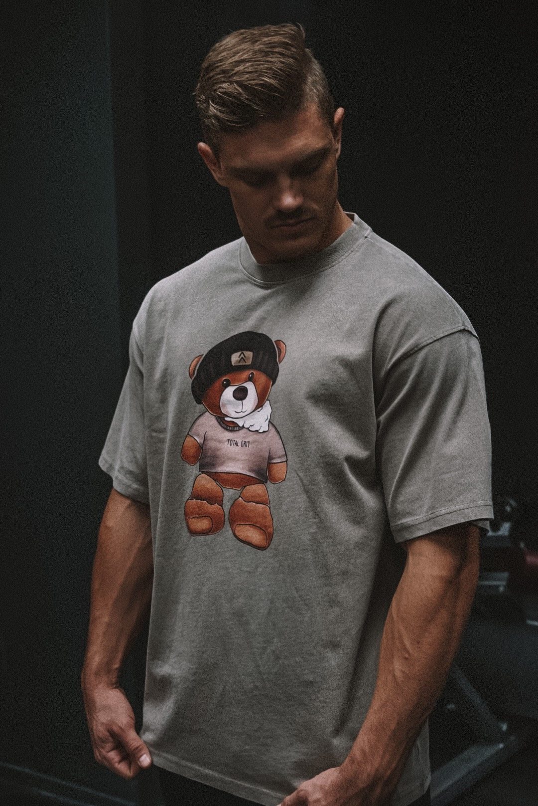 Frontside view of our male model rocking the Beanie bear tee in some gnarly down-lighting.