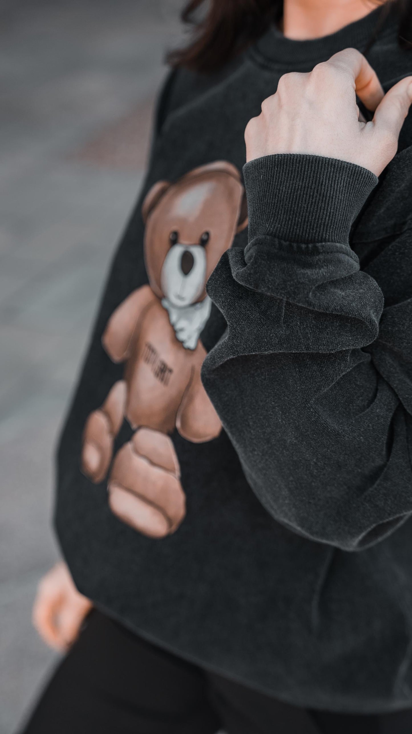 Teddy Long Sleeve Crewneck close up. showing details of the washed black fabric.