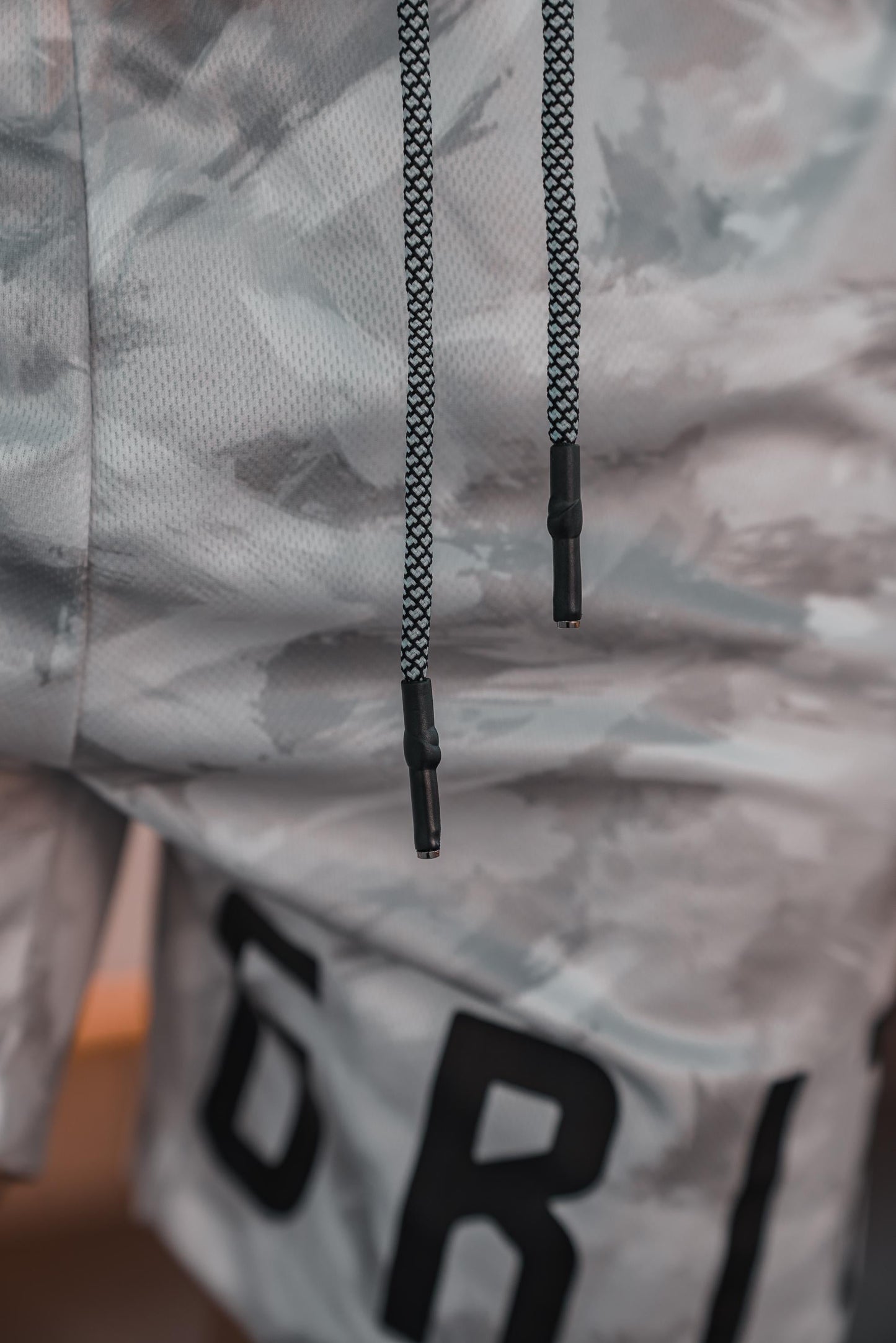 Close up of the white camo shorts, showing off the custom drawstrings.
