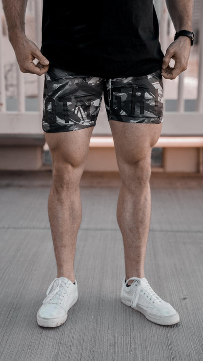 Front on shot of the dark grey camo shorts showing off the Total Grit logo across the front of the shorts.